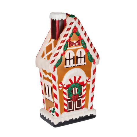 This cute blow mold looks like a classic gingerbread house, complete with a smiling gingerbread man waiting to greet guests outside the house. . Blow mold gingerbread house